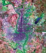 Thumbnail of Laredo, Texas (east of the Rio Grande river) and Nuevo Laredo, Taumalipas (west of the river). Blue, water; green, vegetation; blue-violet, roads and buildings; blue-violet areas on the western side of Nuevo Laredo, low-income neighborhoods; pink, land with little or no vegetation. (National Aeronautics and Space Administration (NASA)/U.S. Geological Survey LANDSAT 7 image [TM bands 7, 4, and 3];courtesy of NASA.)