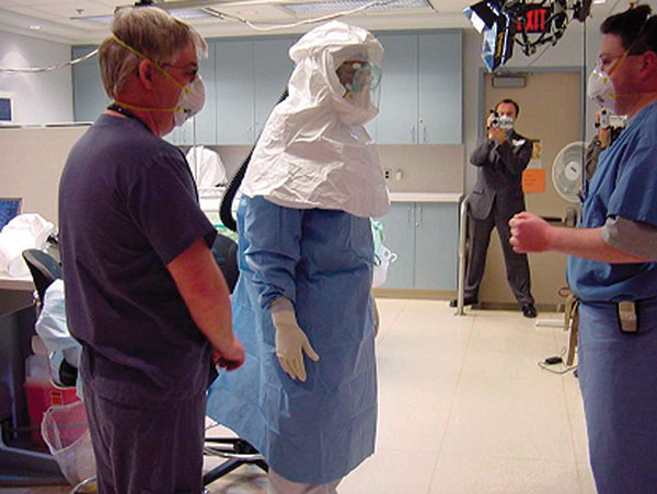 Healthcare worker wearing powered air-purifying respirators for demonstration. Photos provided by Randy Wax and Laurie Mazrik, Ontario Provincial SARS Biohazard Education Team.