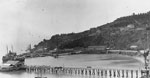 Thumbnail of Naval Training Station, San Francisco, California. View looking south over the wharf area, from the eastern end of Yerba Buena ("Goat") Island, 1921. Long Wharf is in the foreground, lined with rowing boats on davits. Beyond is Navy Wharf, with the receiving ship Boston (1887–1946) at far left. The Lighthouse Wharf is beyond that. Collection of Eugene R. O'Brien. Photo #NH 100361. US Naval Historical Center photograph. From US Naval Historical Center (available from http://www.histo