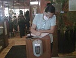 Thumbnail of A reopened restaurant in Mexico City, Mexico, illustrating mask use by the person greeting entering customers and a hand hygiene dispenser that all entering customers were required to use, May 2009. Photo courtesy of Carlos del Rio.