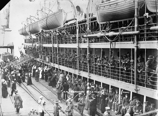 His Majesty’s New Zealand Transport Tahiti with World War I troops alongside a wharf (c. 1915). This photograph was presumably taken in a Wellington, New Zealand, wharf, given the gauge of the railway tracks and the crane type. Photograph was taken by David J. Aldersley (24).