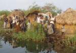 Thumbnail of Fishing camp on an island in Lake Upemba, upper Congo River Basin. Fishermen and their families usually spend several weeks every year in camps like this, in which the lake is the only source of water. Because there is no firewood in such areas, campaigns promoting the boiling of water are useless. (Photograph by Didier Bompangue.)