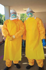 Thumbnail of Example of personal protective equipment (PPE) used during the Centers for Disease Control and Prevention Ebola Safety Training Course, held at the US Federal Emergency Management Agency Center for Domestic Preparedness in Anniston, Alabama, USA, 2014–2015. From top to bottom: head covering, eye protection, N95 respirator, apron over coverall, 2 pairs of latex gloves, gum boots.