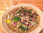 Thumbnail of The bear meat dish implicated in an outbreak of Trichinella T9 infection, Japan, December 2016. Bear meat slices are marked with a circle and an arrow.